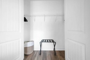 A room with a wooden floor, a metal bench, and a white wall with a ceiling grid. - Good Day Sunshine by Stay on 30a (Seacrest Beach)