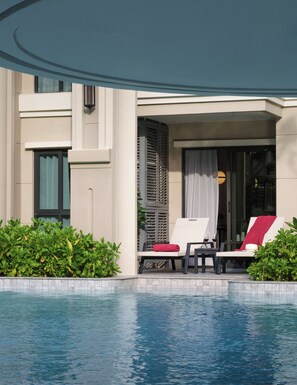 A poolside area with lounge chairs and a covered seating area. - Bang Tao - Terrace by the Pool (Tambon Choeng Thale)