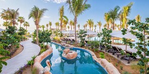 A pool area with lounge chairs, palm trees, and a curved pathway. - Spectacular CABO OceanFront PH-Lux Panorama-3Bd/4b (San José del Cabo)