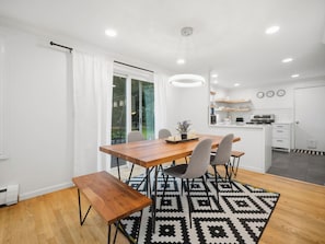 A modern kitchen with white cabinets, a built-in oven, and a microwave. - South Hill Mid Century Bliss (Spokane)