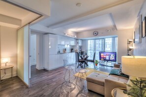 A modern apartment with a kitchen, dining area, and living room.