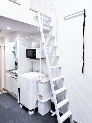 A compact kitchen with a microwave, coffee maker, and a white refrigerator. - Triphome Koenji Minami 4 min to subway (Suginami City)
