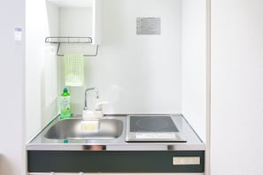 A bathroom with a sink, a mirror, a towel rack, and a bottle of liquid soap. - Triphome Tateishi Free WiFi Asakusa SkyTree (Katsushika City)