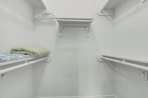 A small, white, enclosed room with a bunk bed, a hanging clothes rack, and a shelf. - Waterfront Oasis Bay Views near NASA & Kemah (Seabrook)