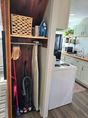 A compact kitchen with a built-in stove, a microwave, and a sink. - UrbanCottage | 1mi Mayo Clinic, No Stairs, Dogs OK (Rochester)