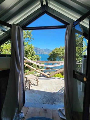 A room with a view of the sea, a hammock, and a wooden deck. - Our Birdhouse - Relax & Swim - Your Peaceful Getaway (San Pedro La Laguna)