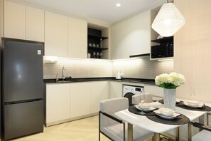 A modern kitchen with a built-in LG refrigerator, a microwave, and a washing machine. - Bang Tao - Tropical Pool & Garden View (Choeng Thale)