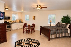 A compact living space with a kitchenette, dining area, and a bed. - Spacious 4-bedroom house in peaceful Houston with Fenced Yard! (Houston)