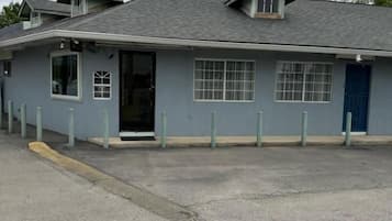 A building with a flat roof, a door, and windows.