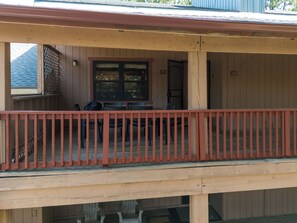 A wooden balcony with a red railing, a door with the number 32, and a window. - Pine Top Loft - Walk to Lifts, Ski Locker, Deck (Angel Fire)