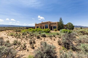 A modern house with a desert landscape in the background.