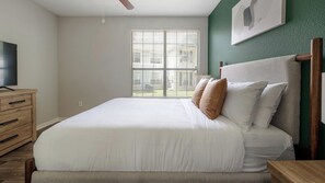 A bedroom with a bed, wooden dresser, and a television. - Landing | Spectacular 1BD, Clubhouse, Gym (Murfreesboro)