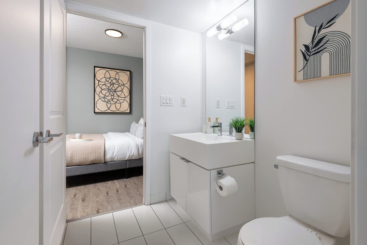 A modern bathroom with a toilet, sink, and shower area.