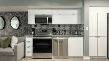 A modern kitchen with stainless steel appliances, a built-in oven, and a dishwasher.