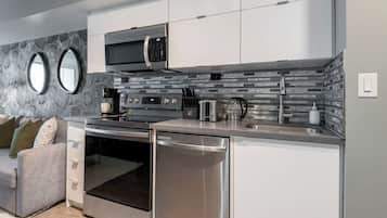 A modern kitchen with stainless steel appliances, a built-in oven, and a microwave.