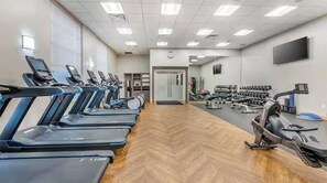 A gym with treadmills, weights, and exercise equipment. - 2-bedroom hotel suites in peaceful Orlando walking distance to Universal (Orlando)