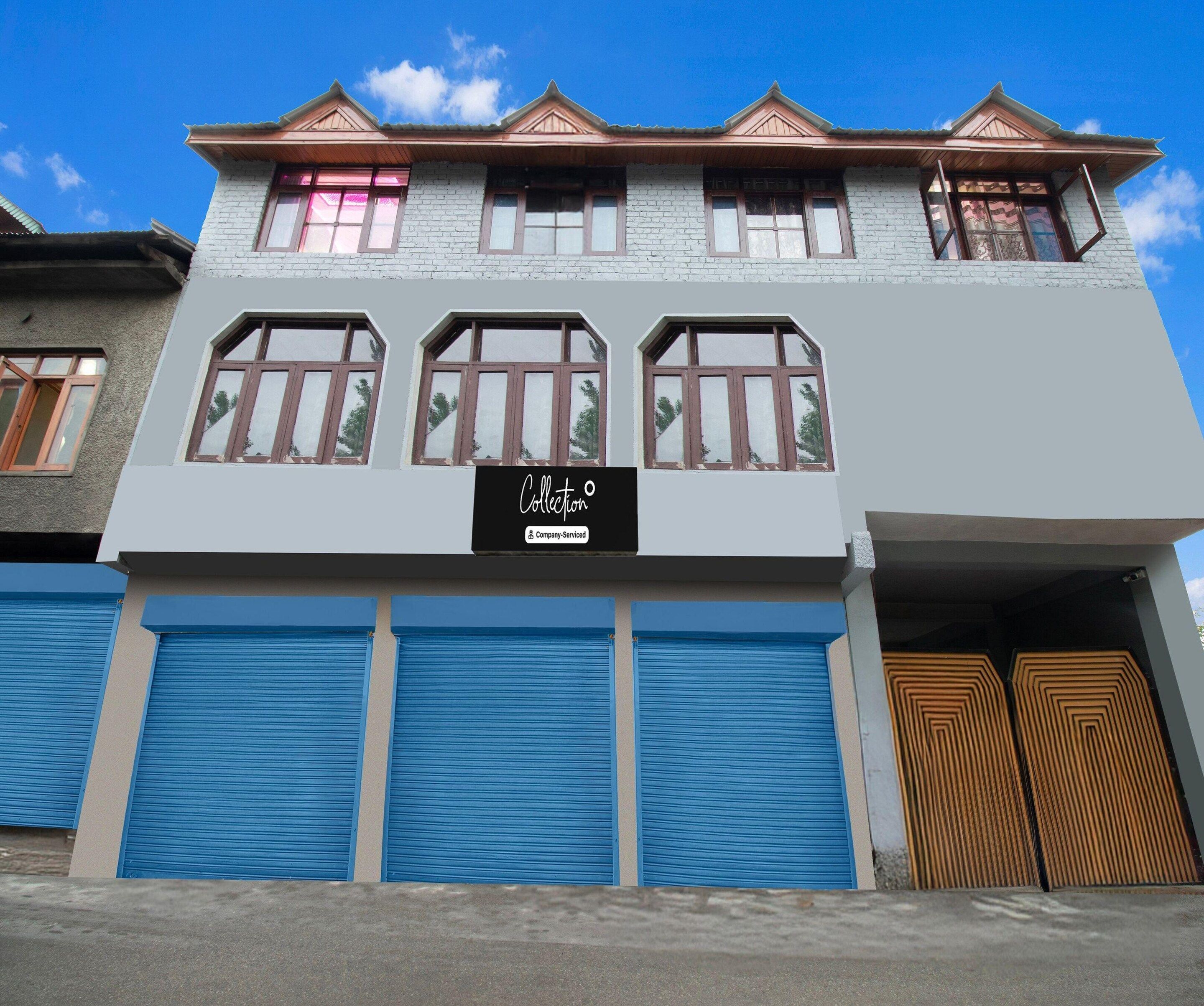 A two-story building with a sign indicating it's a company-serviced collection.