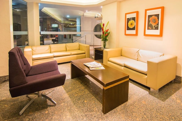 Unwind on plush sofas in a bright, stylish lounge.