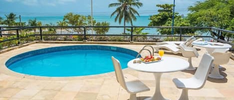 Dive into a sunlit pool with sweeping ocean views.