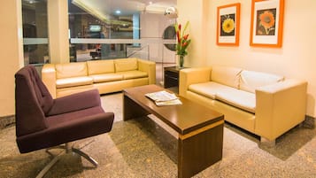 Unwind on plush sofas in a bright, stylish lounge.