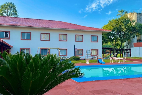 Dive into sunshine by the sparkling pool and loungers.