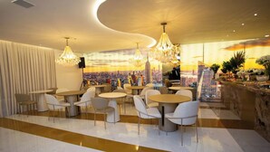 A modern restaurant with round tables and chairs, a cityscape mural on the wall, and a view of the city skyline. - Scenic Room Close to Perequê Beach – Walkable Stay with Free Breakfast Buffet! (Santa Catarina)