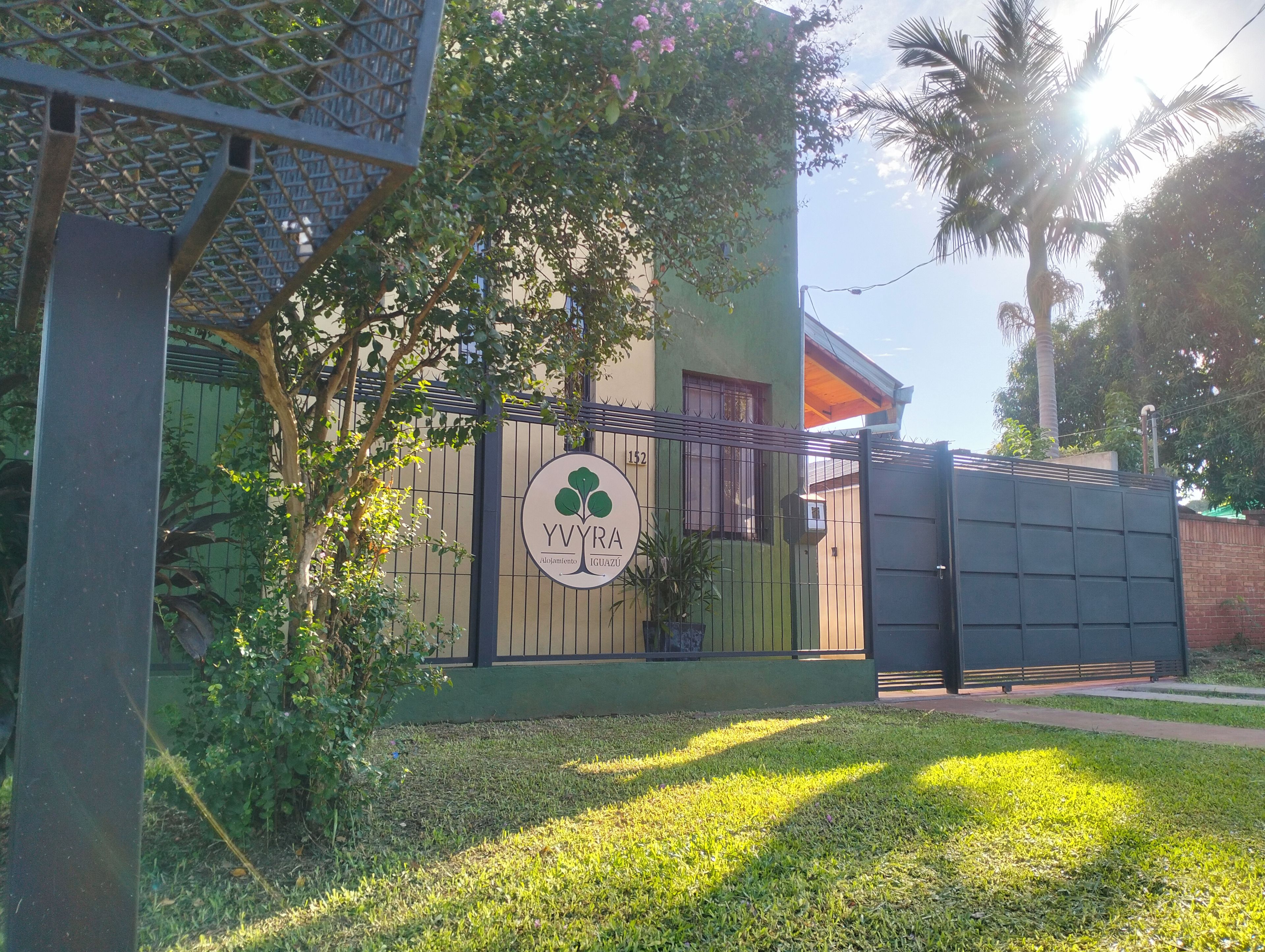 A gated property with a sign indicating 'YVYRA Alquiler' and a number '152'.