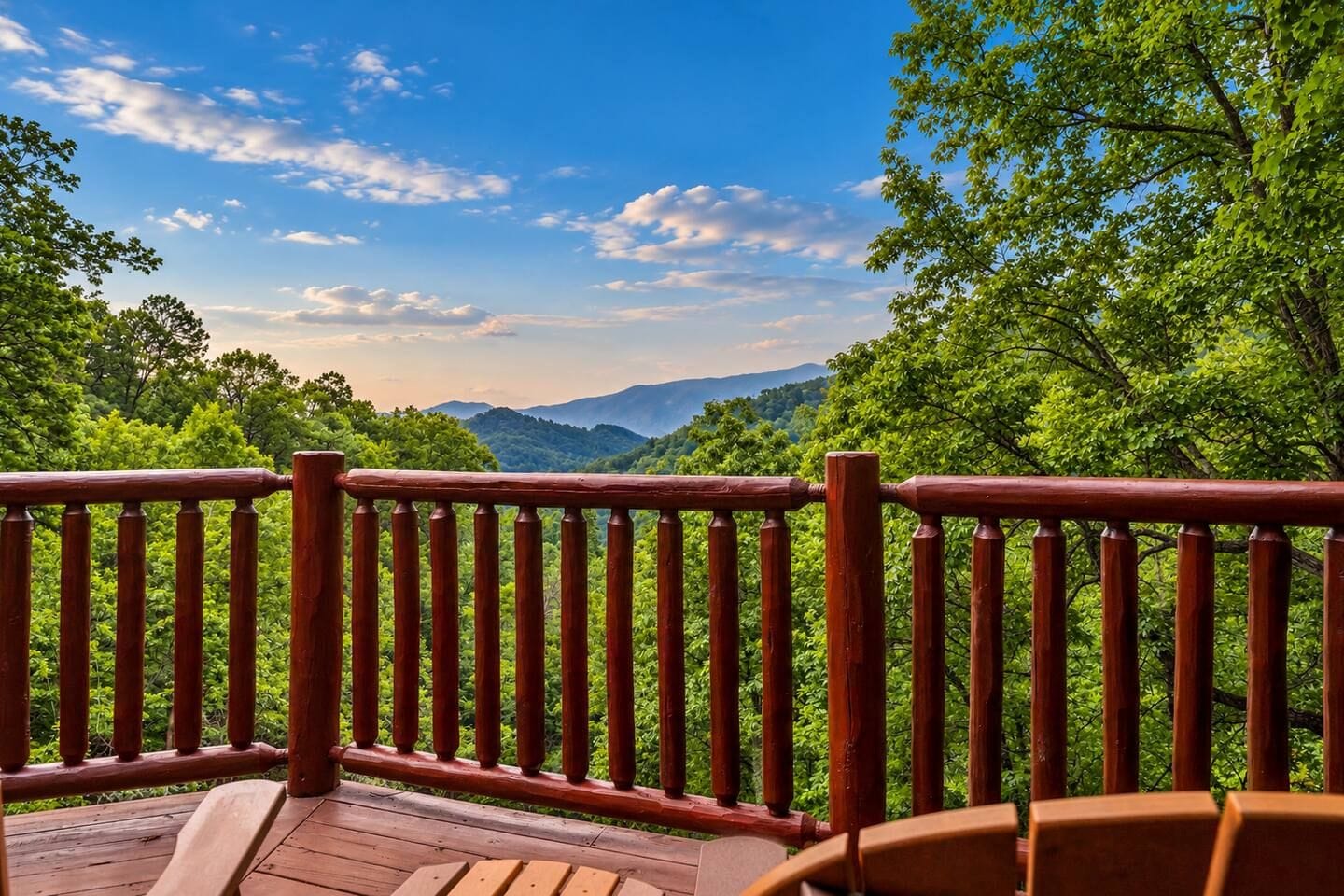A wooden deck with a railing overlooking a mountainous landscape.