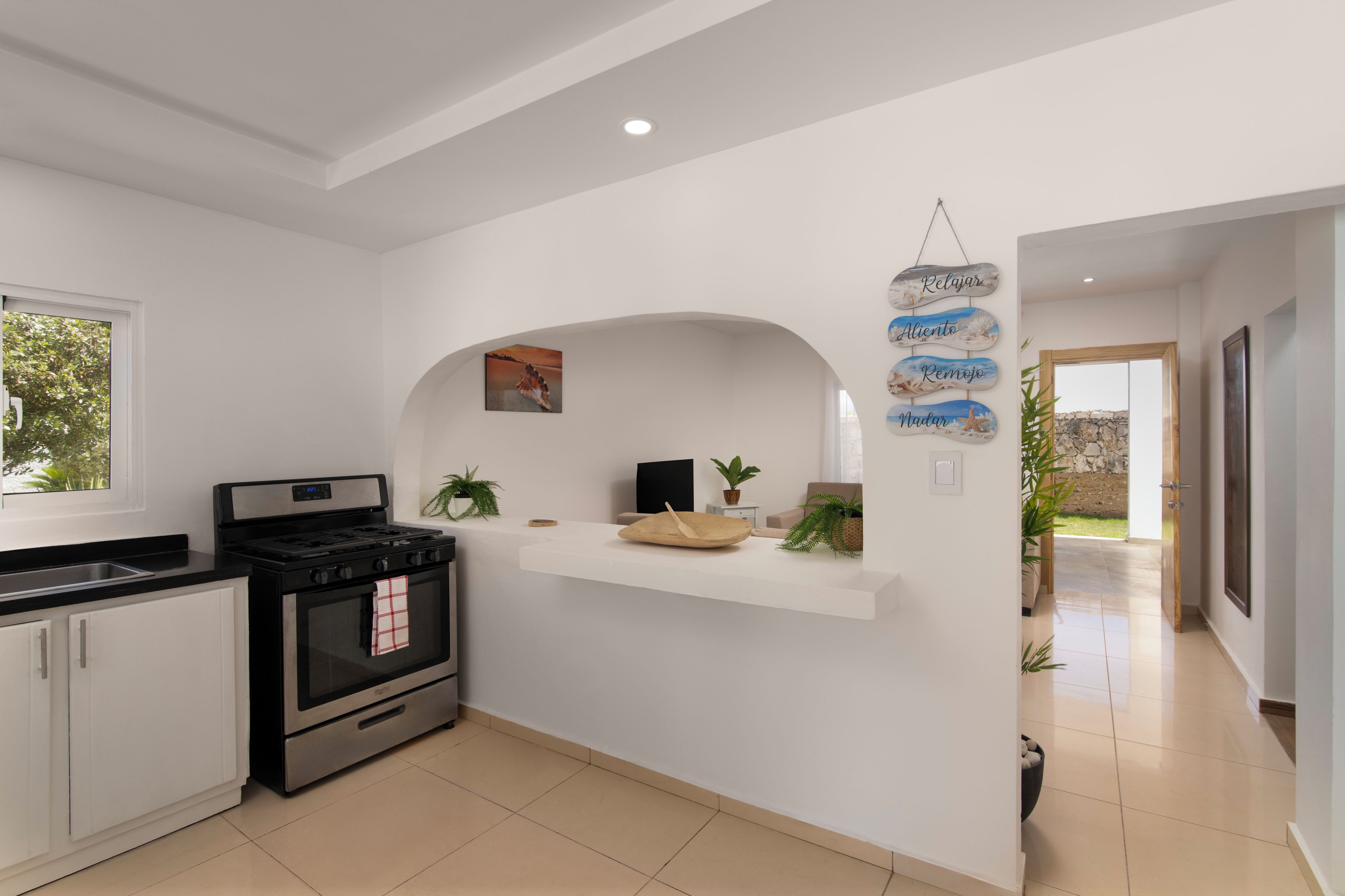 A modern kitchen with a built-in stove, oven, and a small island with a sink.