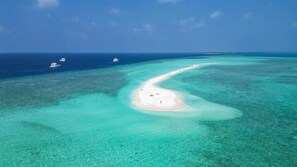 An aerial view of a beach with clear turquoise waters and a small white sandbar. - Anam Villa Maldives - Modern 4 room private villa (Dharavandhoo)