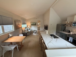 A modern kitchen with a marble countertop, a built-in oven, and a microwave. - Walkable-Stylish-BRAND NEW! (Raleigh)