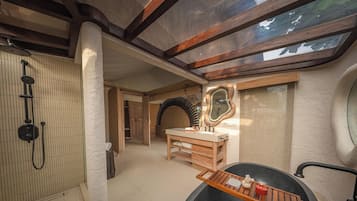 A bathroom with a shower, a vanity with a mirror, and a bathtub.
