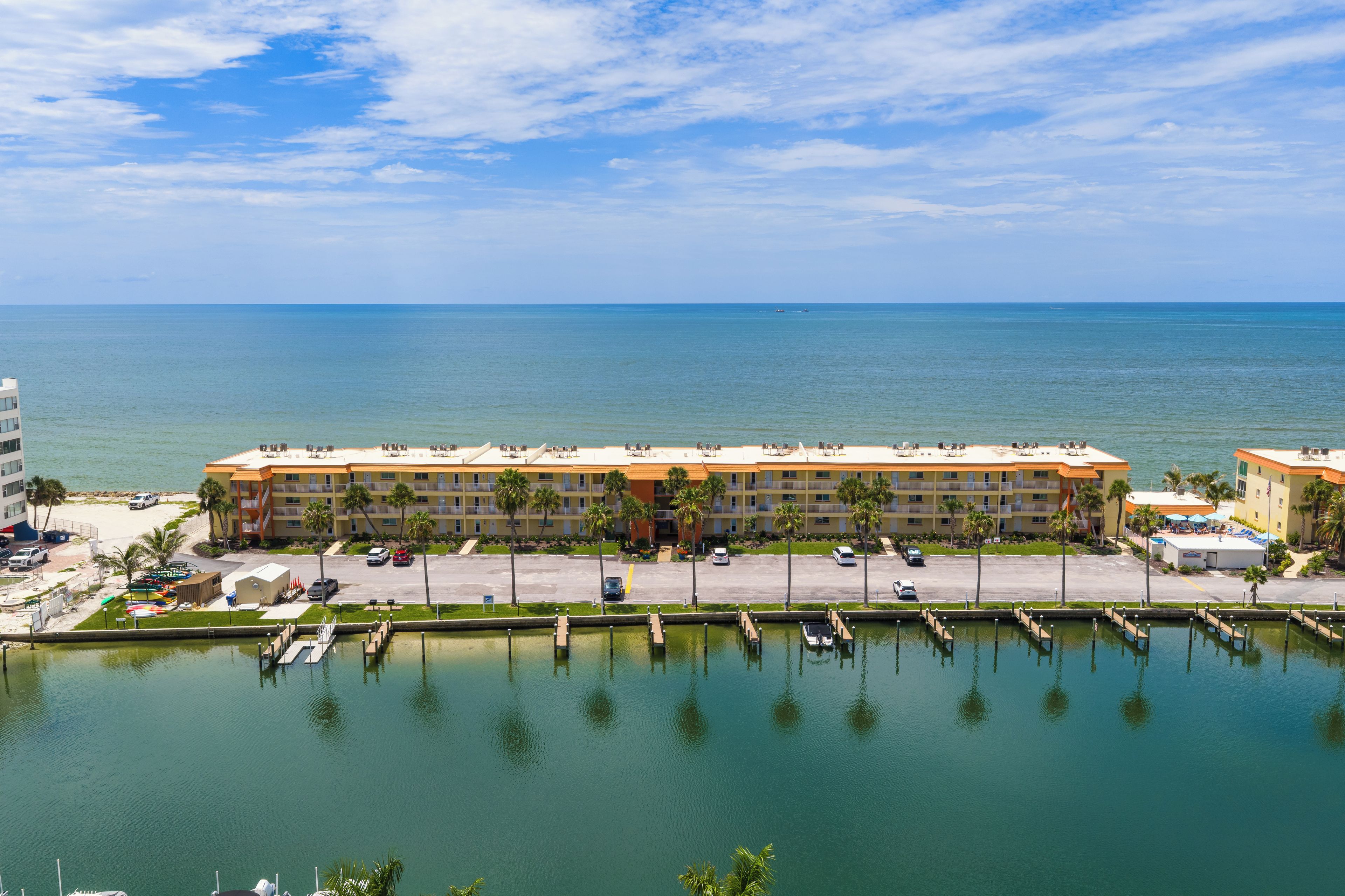 A hotel with a marina, multiple balconies, and a view of the sea.