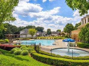 A residential area with a swimming pool, lounge chairs, and a gazebo. -     Stylish 4BR Home, Fenced Yard, Office + Tesla Charger (Dallas)
