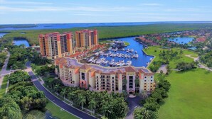 A resort with multiple high-rise buildings, a marina, and surrounding greenery.