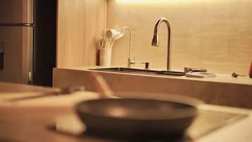A kitchen with a modern faucet, a sink, and a pan on the countertop.