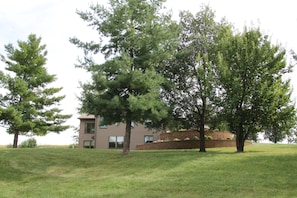 A two-story building with a brick exterior and a grassy lawn.