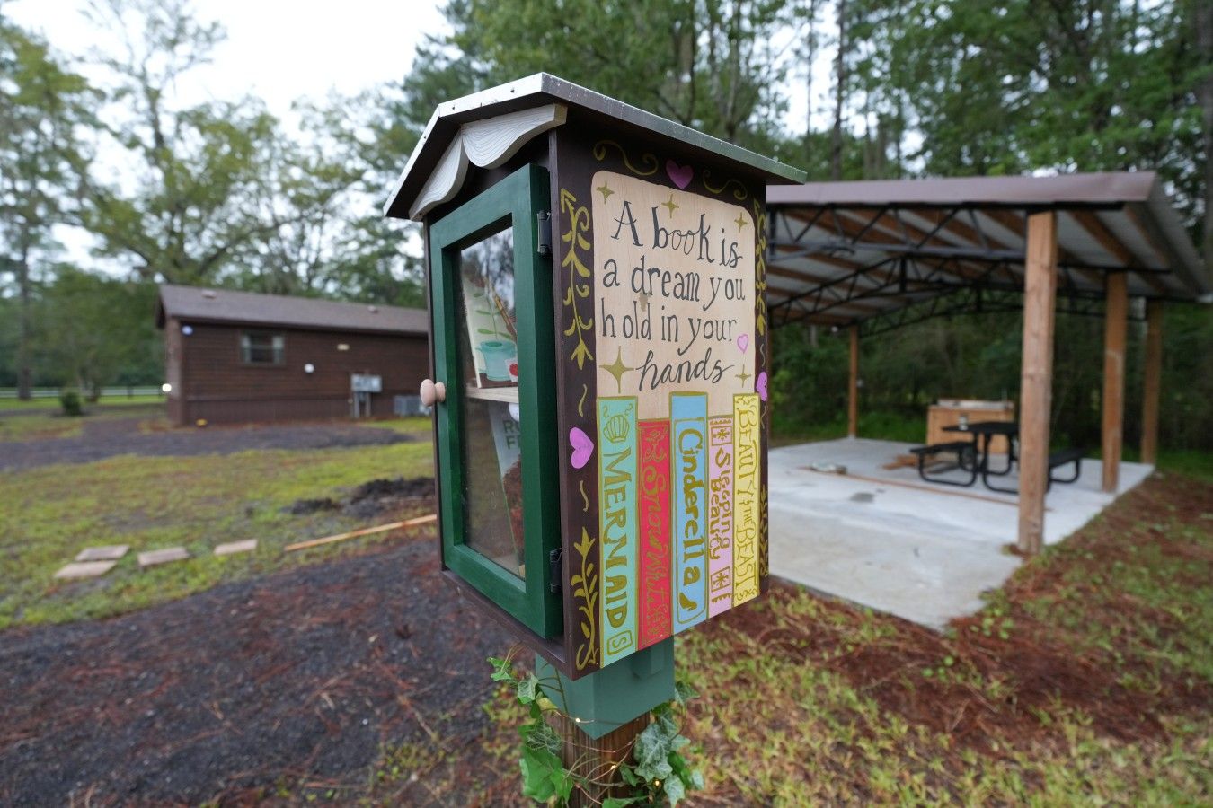 A book-themed outdoor display with a sign stating 'A book is a dream you can hold in your hands.'