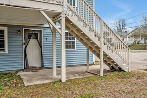 A residential building with a single-story structure, a front porch, and a staircase leading to the entrance. - 8 Min to Duke + DT | Free Parking + Wi-Fi (Durham)