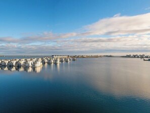 A marina with boats docked, calm water, and a clear sky. - Houseboat in Olpenitz With Swimming Pool (Kappeln)
