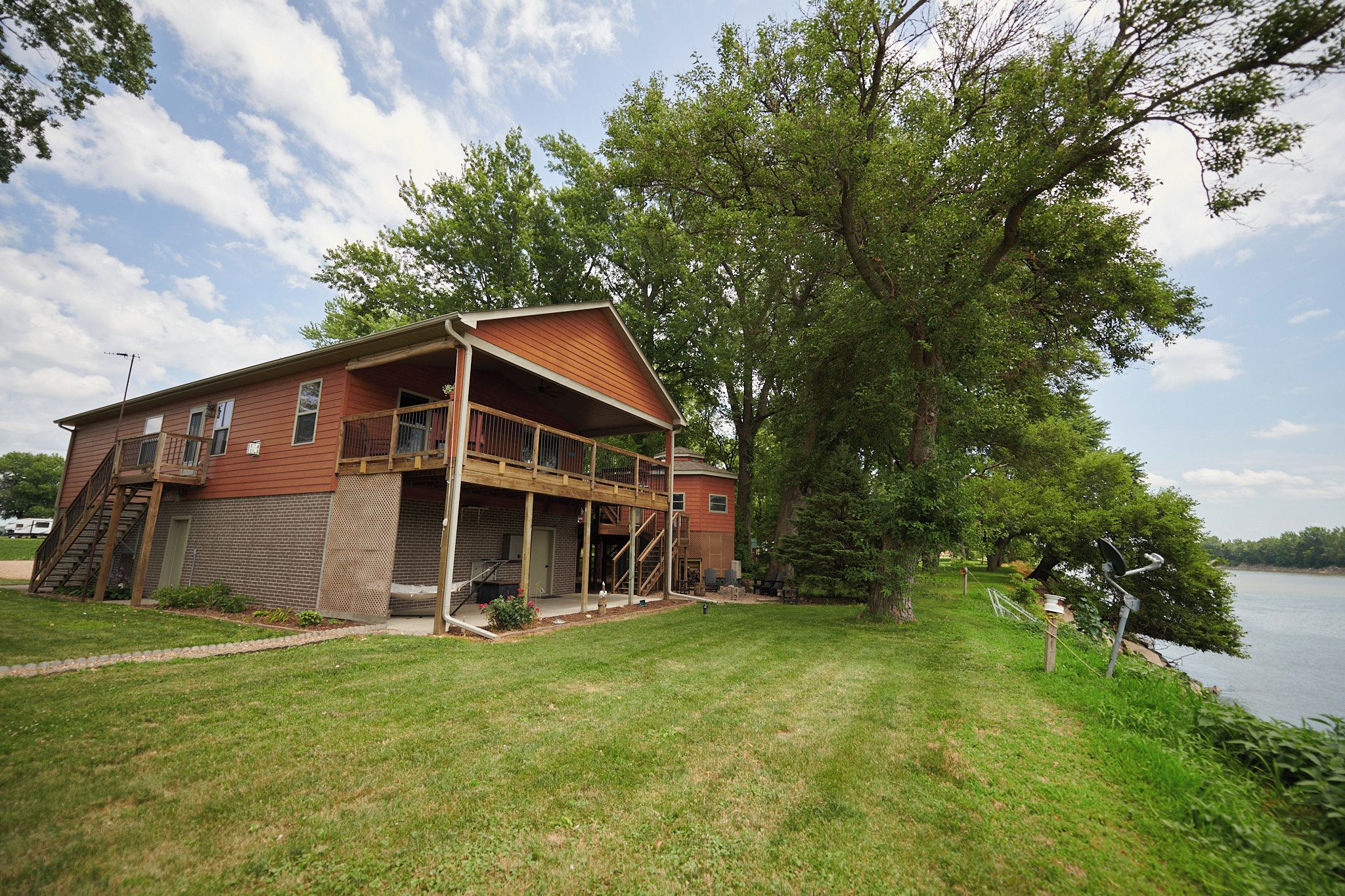A two-story house with a covered porch and a garage.
