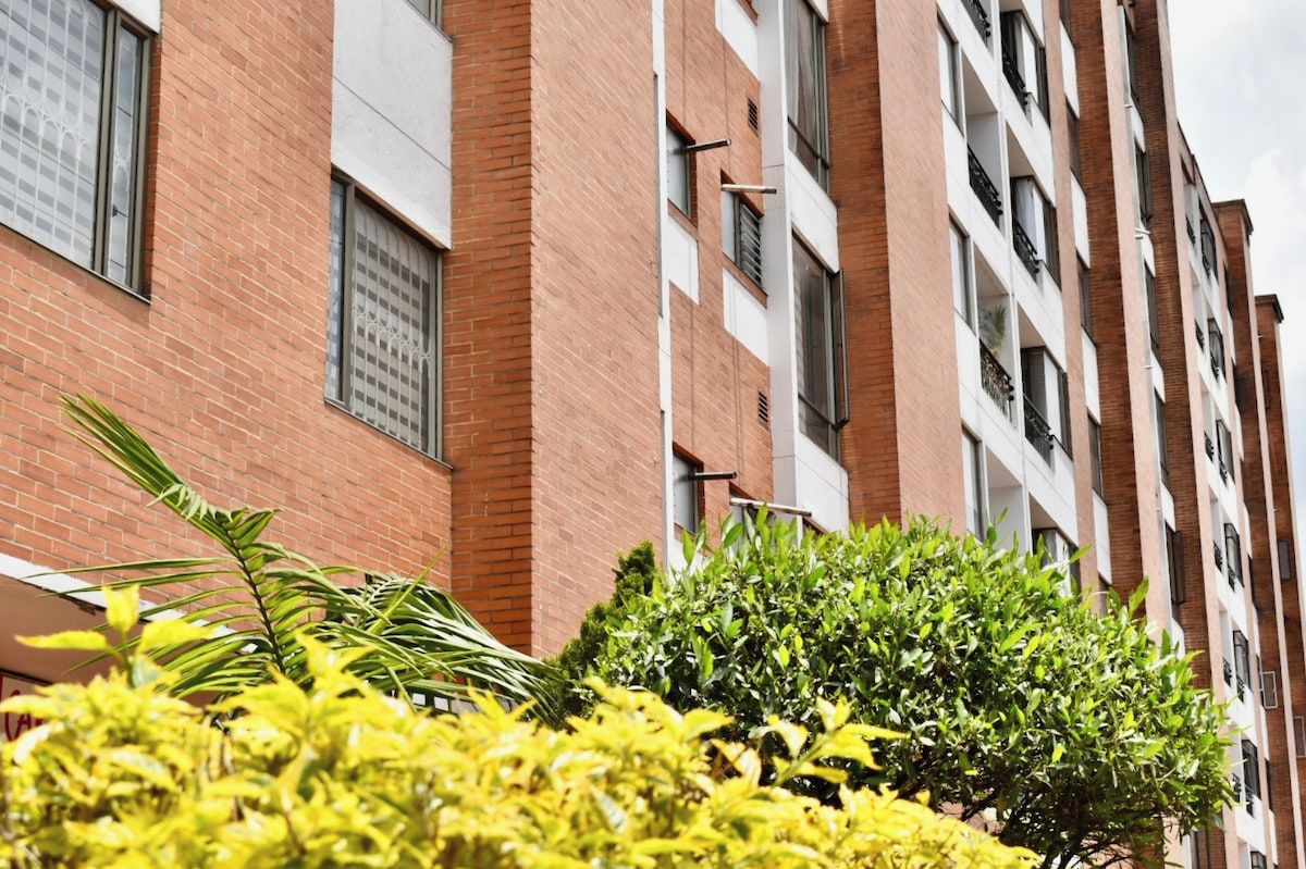 A multi-story building with brick facades and balconies.