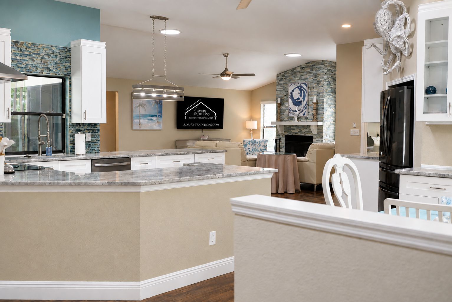 A modern kitchen with a central island, white cabinetry, and a stone backsplash.