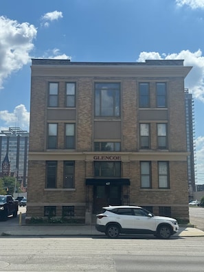 A multi-story building with a storefront labeled 'GLENCOE' at the ground level. - Historic Home Away From Home (Indianapolis)