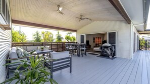 An outdoor covered patio with a wooden deck, seating area, and a grill. - The Retreat - South Mission Beach (South Mission Beach)