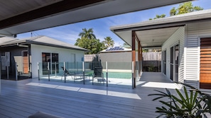 A modern outdoor deck with a pool, glass doors, and a covered area. - The Retreat - South Mission Beach (South Mission Beach)