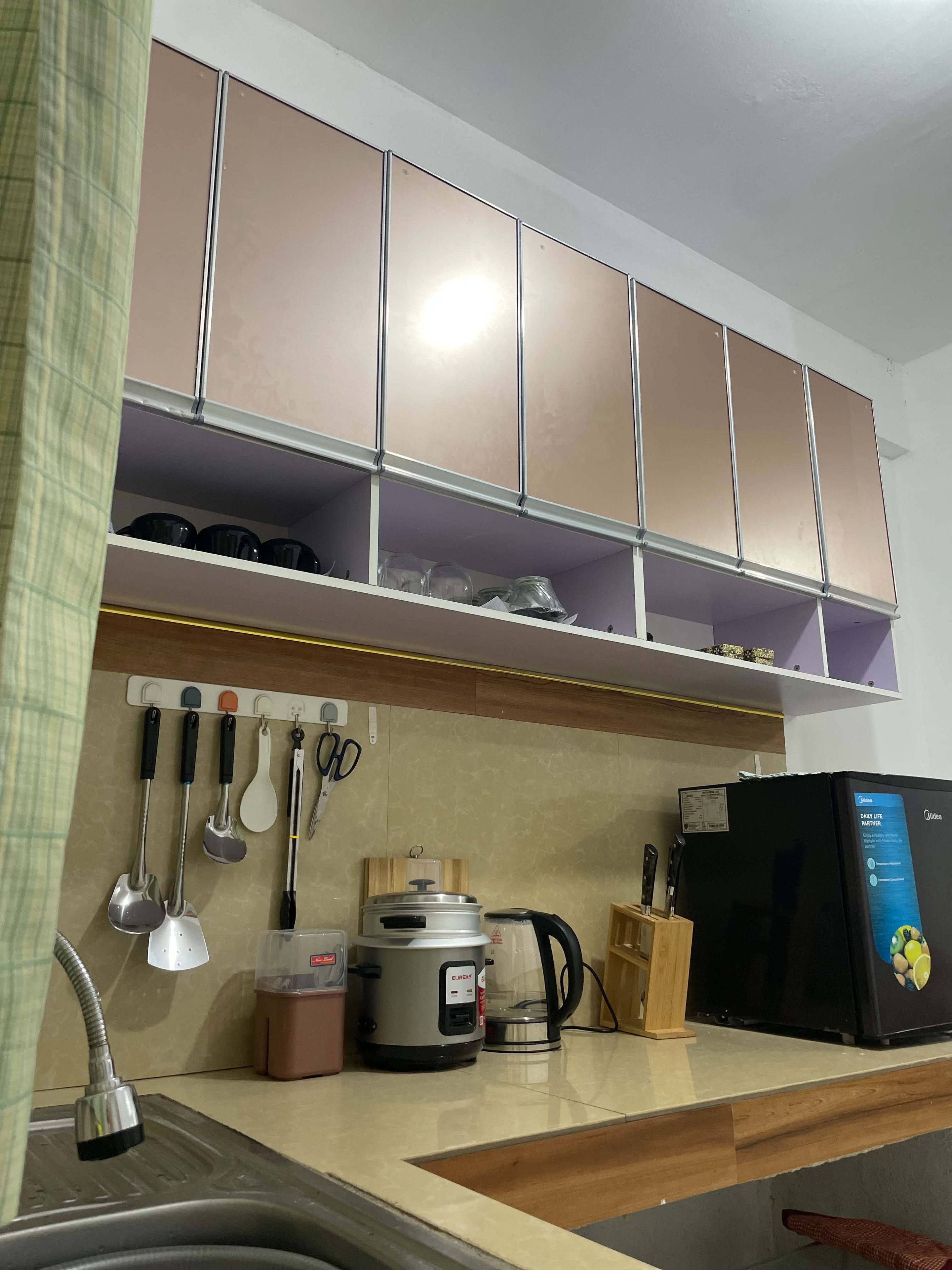A kitchen with a sink, countertop, and cabinets.