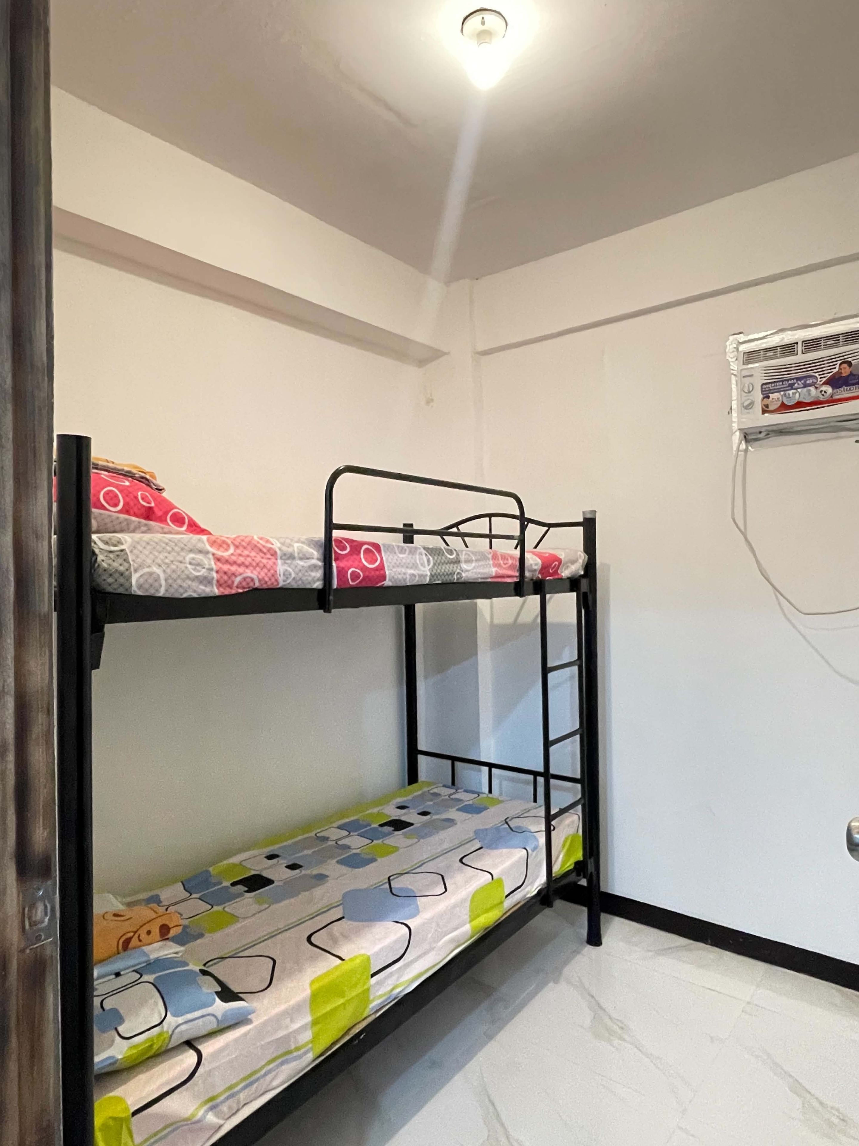 A bunk bed with a mattress featuring a geometric pattern.