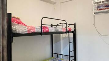 A bunk bed with a mattress featuring a geometric pattern.