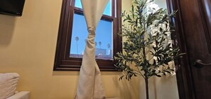 A room with a window, a curtain, and a potted plant. - La Casita: A Mediterranean Oasis Nestled in the Heart of Santa Monica (Santa Monica)
